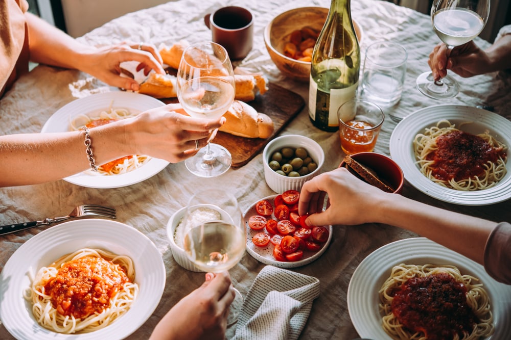 Friends enjoying pasta in an italian restaurant in houston