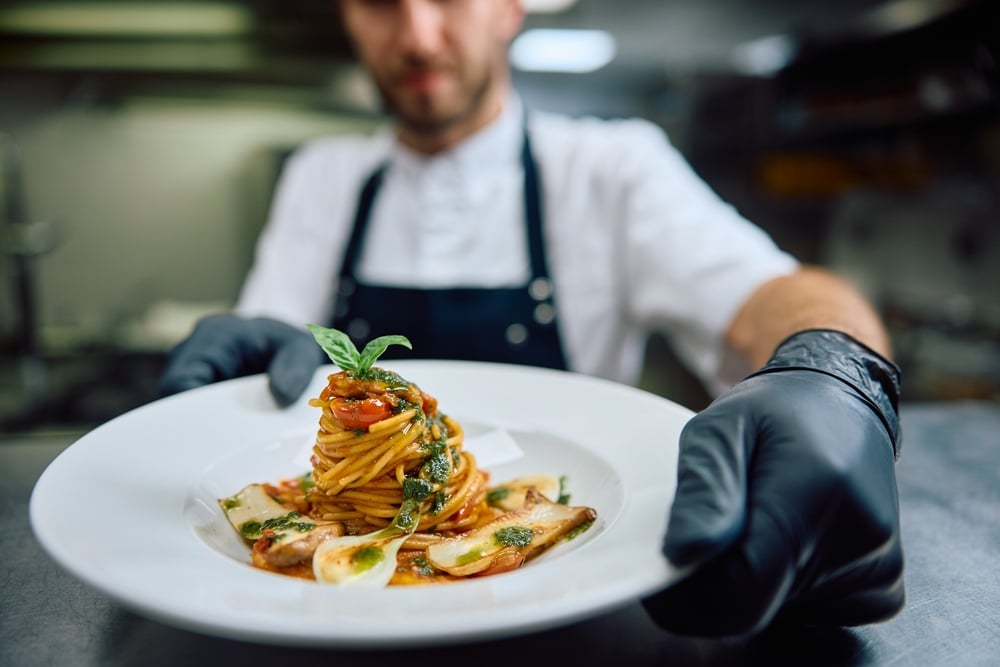 Chef serving dishes in Italian restaurant in houston